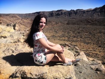 Woman sitting on rock