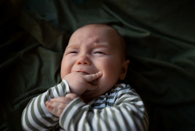 Portrait of cute baby boy sleeping on bed