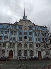 Low angle view of building against cloudy sky