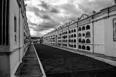 Street amidst buildings in city against sky