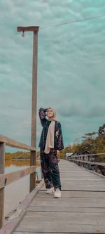 Woman with umbrella walking on footpath