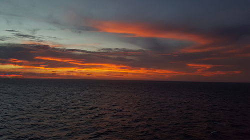 Scenic view of sea against romantic sky at sunset