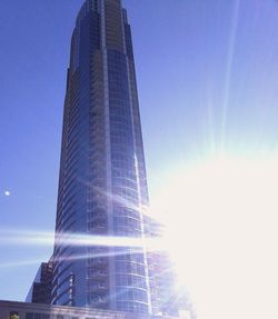 Low angle view of skyscrapers against blue sky