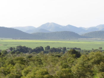 Scenic view of landscape and mountains against sky