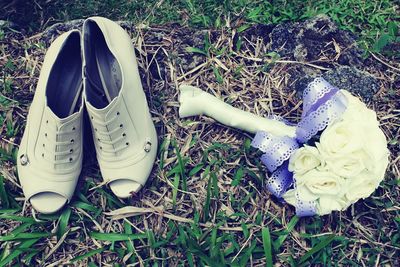 Close-up of shoes on grassy field