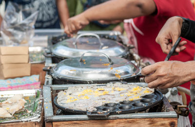 Midsection of man preparing food