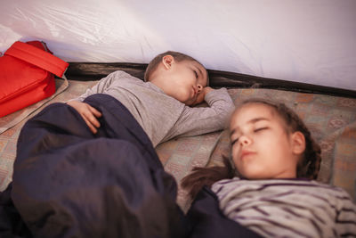 High angle view of boy sleeping on bed