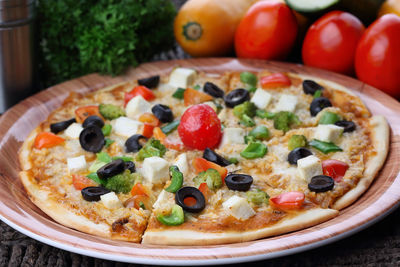 Close-up of pizza in plate on table