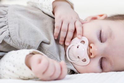 Close-up of baby sleeping at bed