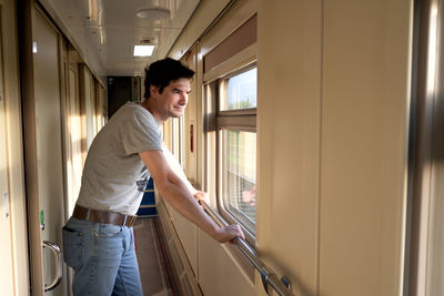 Man travels alone by train and looks out