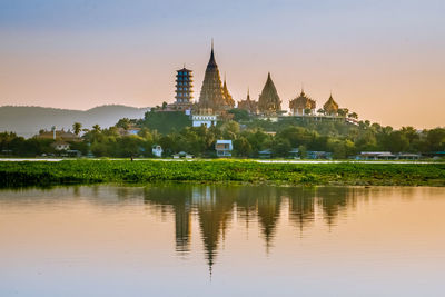 Reflection of building in lake at sunset