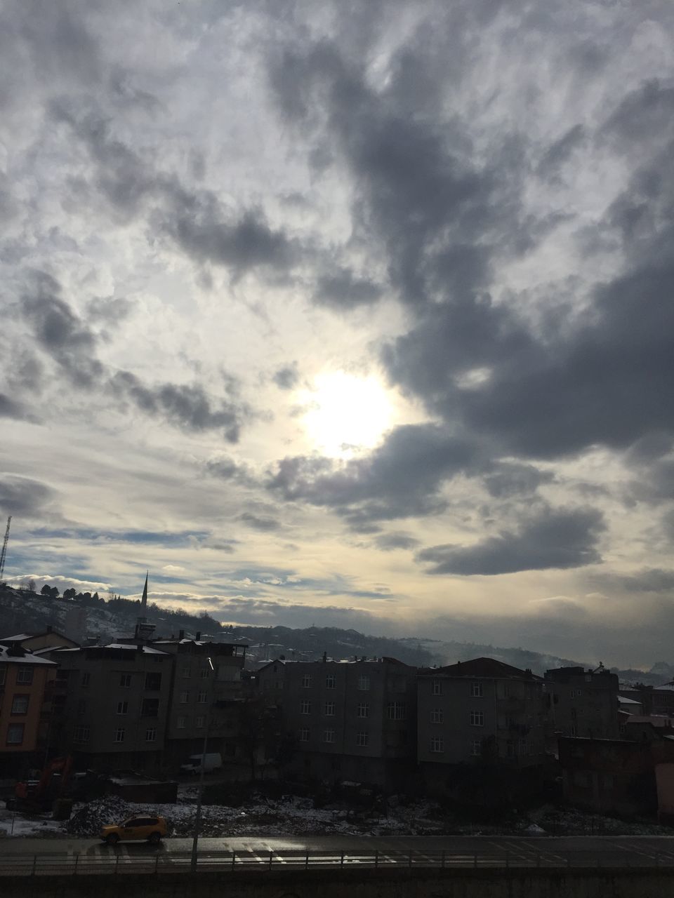 VIEW OF TOWN AGAINST SKY AT SUNSET