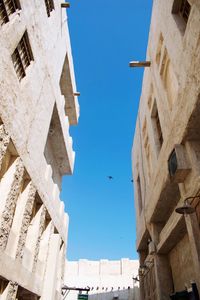 Low angle view of buildings against blue sky