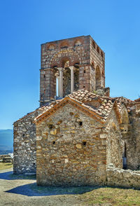 Low angle view of old building against blue sky