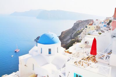 Panoramic view of sea and buildings against sky