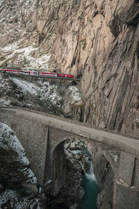 Bridge over rocks against mountains