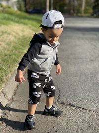 Baby boy walking on street