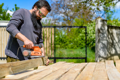 Low angel view of carpenter working outdoors