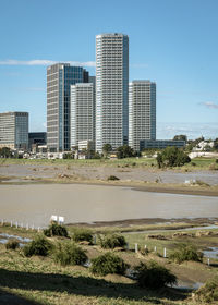 Modern buildings in city against sky