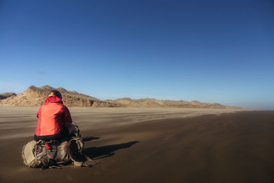 Rear view of man riding motorcycle on landscape