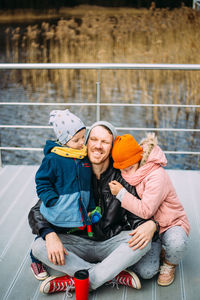 Father and two children walk in nature in autumn, spend time together, have fun.