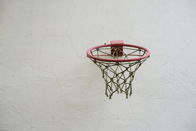 Close-up of basketball hoop against wall