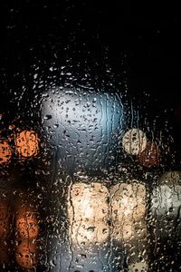 Full frame shot of wet glass window in rainy season