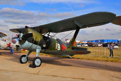 View of airplane at airport runway against sky