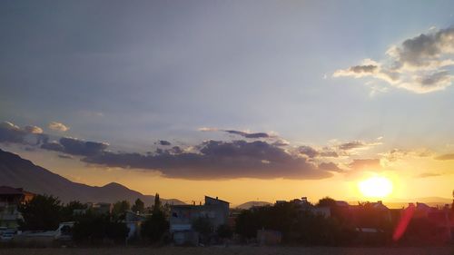 Scenic view of buildings against sky during sunset