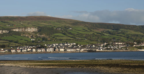 Scenic view of sea and mountains against sky