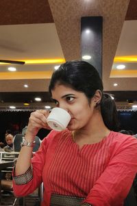 Young woman drinking glass