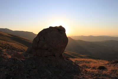 Scenic view of rock formation against sky during sunset