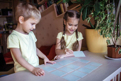 Cute sibling playing at home