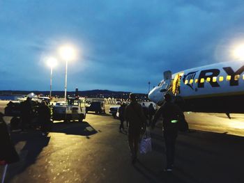 Airplane on airport runway against sky