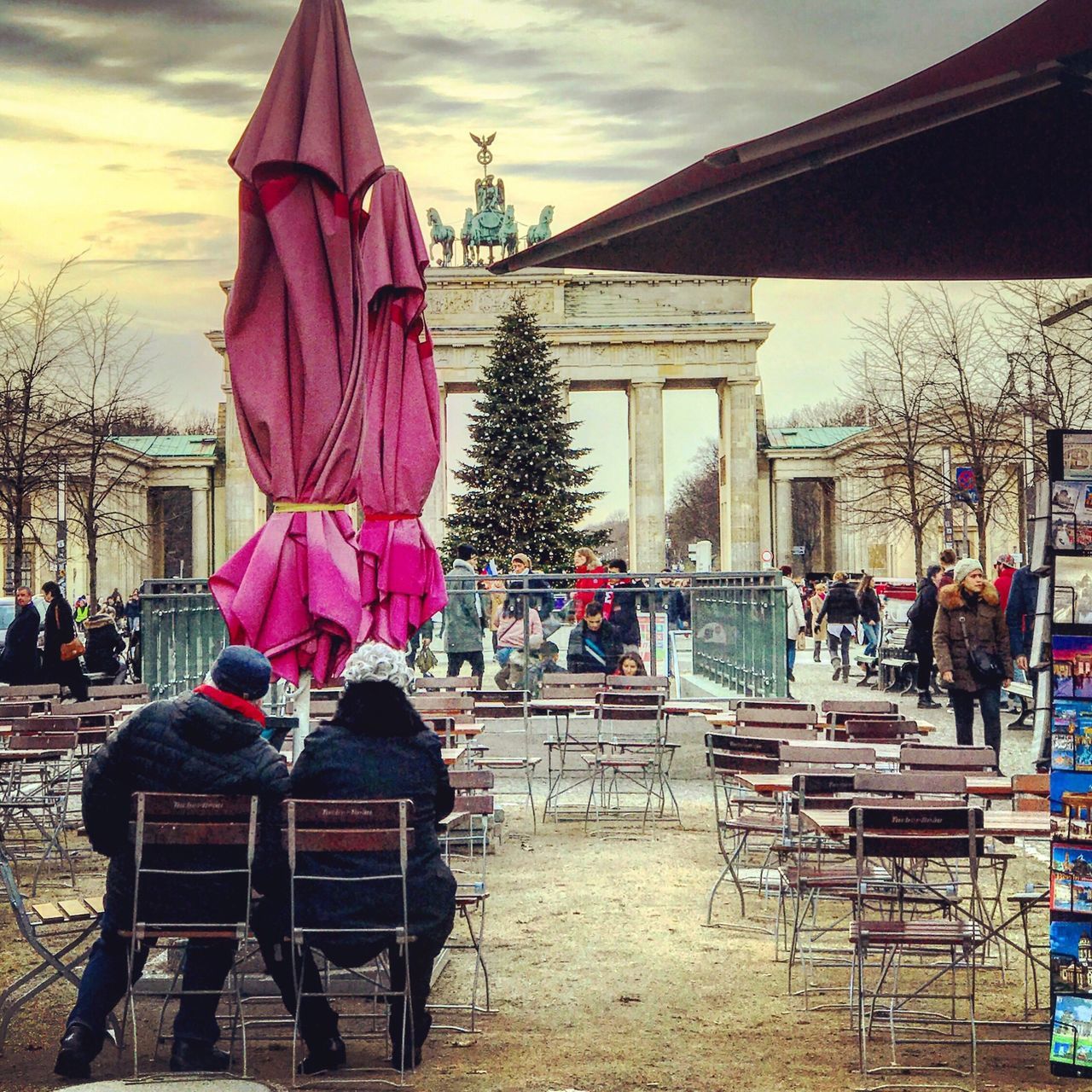 REAR VIEW OF PEOPLE IN TOWN SQUARE