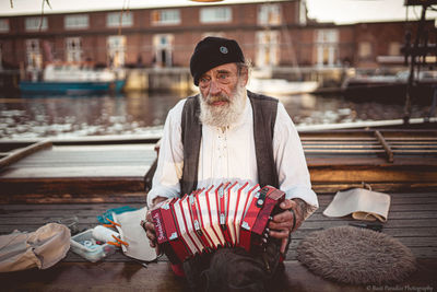 Portrait of man holding umbrella