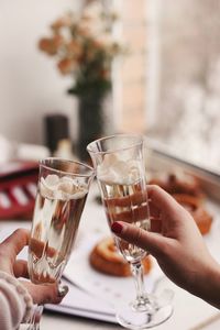 Cropped hands of female friends toasting drinks