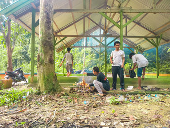 Rear view of people standing by plants