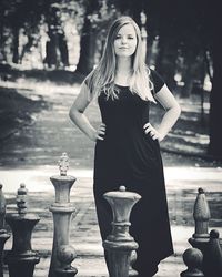 Close-up of woman standing on railing