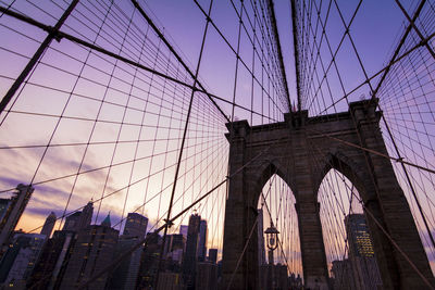 Low angle view of suspension bridge against sky