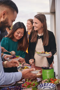 Friends enjoying buffet on terrace