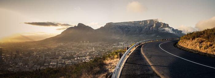 Road amidst cityscape against sky