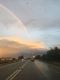 Cars on road during sunset