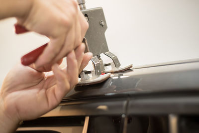 Close-up of hands holding tool