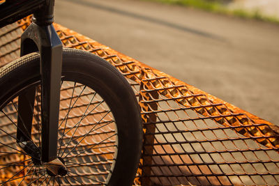 Close-up of bicycle parked on footpath