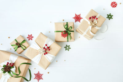 Border of gift boxes wrapped in kraft paper on white wood desk background