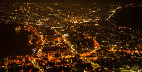 High angle view of illuminated city buildings at night