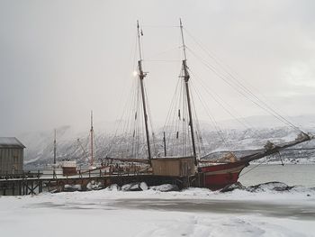 Nautical vessel on frozen lake against sky during winter