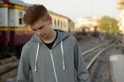 Teenage girl standing on railroad track