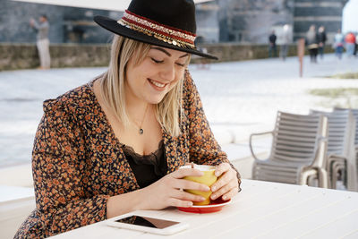 Woman having drink at cafe